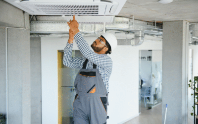 A professional HVAC technician performing AC repair on a modern indoor unit