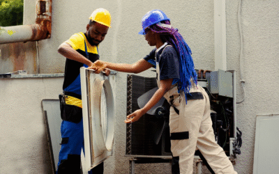 Technicians removing HVAC system panel for inspection and maintenance.