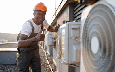 A technician smiles and gives a thumbs up after providing AC Repair Service.