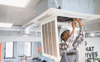 A technician is working on an air conditioning unit.